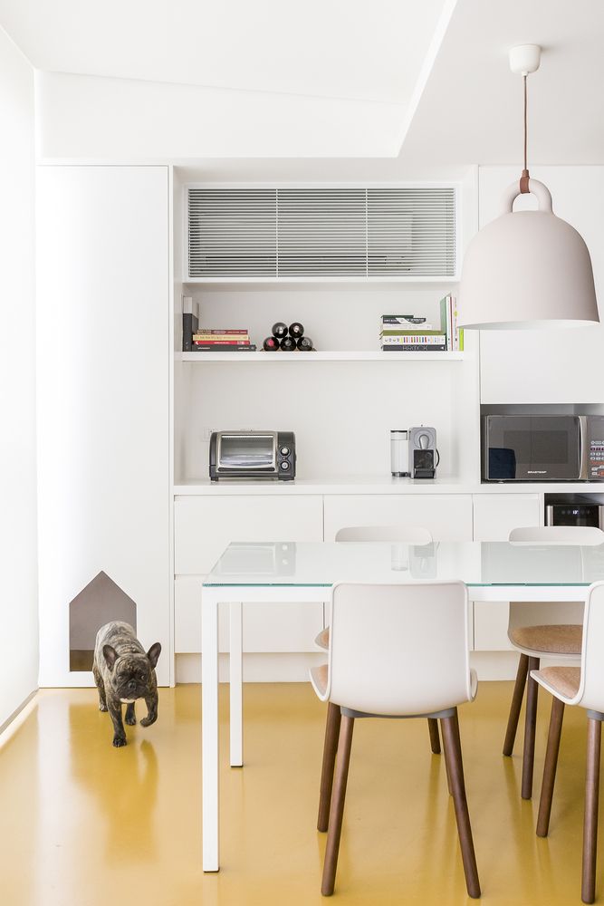 The kitchen and dining area are seamlessly connected and feature a white-based palette